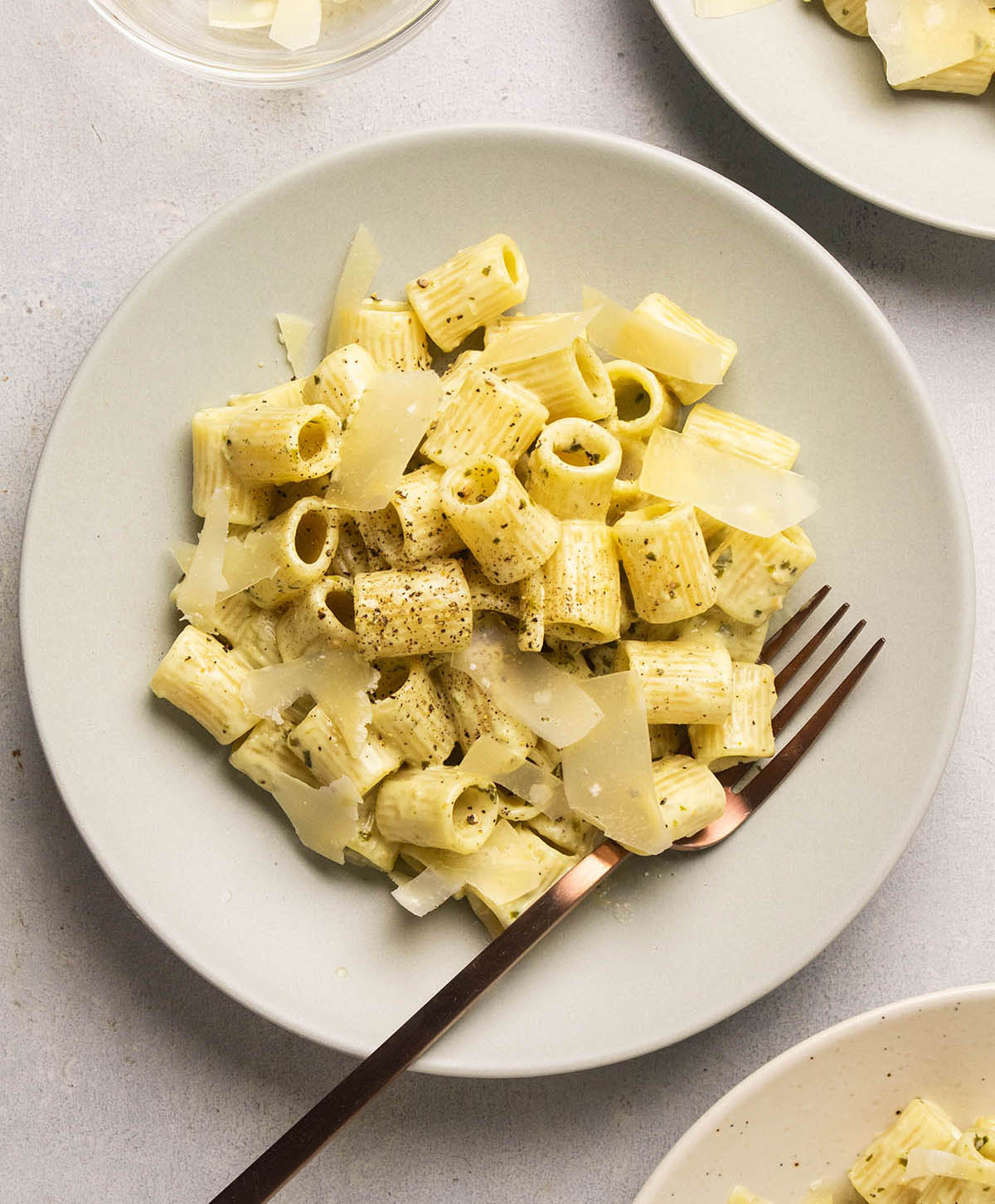 Pesto pasta topped with parmesan.